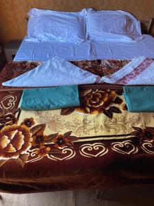 
a bed that has a bunch of pillows on it at Bedouin Roads in Wadi Rum
