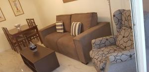 - un salon avec un canapé et une chaise dans l'établissement Piso 2da línea de playa en Marbella, à Marbella
