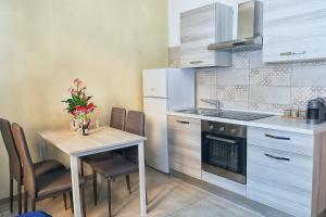 a small kitchen with a table and a sink at RAMA APARTAMENT in Vico Equense