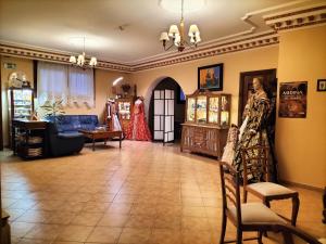 a living room with a woman standing in a room at Hotel Mayno in Pastrana