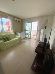 a living room with a couch and a television in it at Casa em Condomínio, Aquiraz - CE in Aquiraz