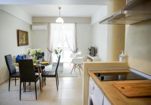 a kitchen and dining room with a table and chairs at Praxitelis Luxury Apartments in Athens