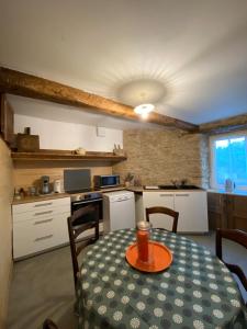 a kitchen with a table with a drink on it at La vieille forge in Boussan +40 photos