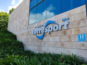 a sign on the side of a building at Hotel Torresport in Torrelavega