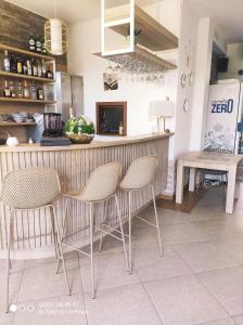 a kitchen with a bar with chairs and a counter at Willa Enigma in Dębki