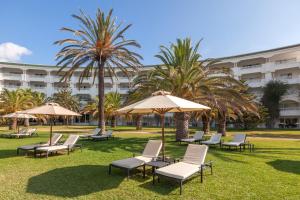 a group of chairs and umbrellas in a park at OCEANA Hotel & Spa in Hammamet