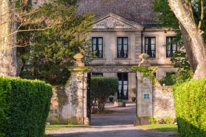 an entrance to an old house with bushes at Domaine d'Auriac - Relais & Châteaux in Carcassonne