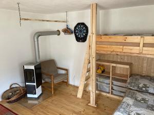 a room with a bunk bed and a chair and a television at Chalupa u Potoka Vikantice in Vikantice +19 photos