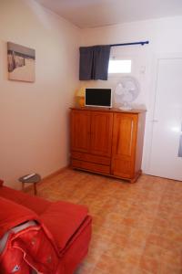 a bedroom with a bed and a desk with a window at A U Mare in Sagone