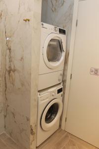 a washing machine and a microwave in a bathroom at Adri & Marg luxury living in Athens