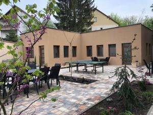 a patio with a table and chairs in front of a building at Second Home Apartments Miskolctapolca in Miskolctapolca