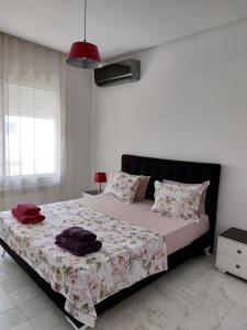a bedroom with a large bed with a bedspread at Harmony Appartement 13 in Tunis