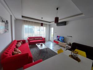 a living room with two red couches and a table at Harmony Appartement 13 in Tunis