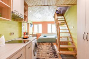 a small kitchen with a staircase leading to a bedroom at INKARAS Aparthotel in Palanga