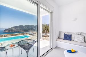 a room with a view of the pool and the ocean at Villa Mariel Skopelos in Skopelos Town