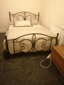 a bedroom with a bed with a metal frame at Carib Inn in Manchester