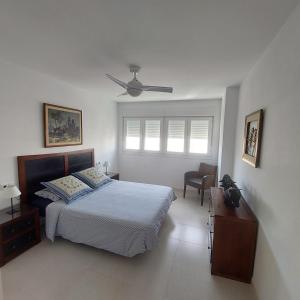 a bedroom with a bed and a ceiling fan at Apartamento frente a la playa Piso 3 in Estepona
