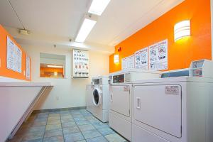 a laundry room with a washer and dryer at Motel 6-East Brunswick, NJ in East Brunswick