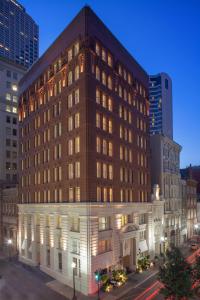 a large brick building in a city at night at International House Hotel in New Orleans