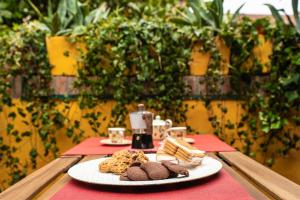 a table with a plate of cookies on a table at Corte Degli Estensi, romantica mansardina in Ferrara