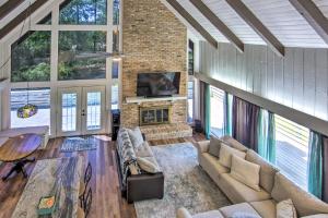 a living room with a couch and a fireplace at Brookeland Resort Cabin with Golf and Lake Access in Brookeland