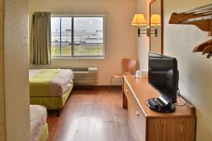 a small hotel room with a bed and a television at Motel 6-Billings, MT - North in Billings
