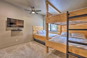 two bunk beds in a room with a ceiling fan at Family-Friendly McCall Cabin Pool Access and Bikes in McCall +34 photos