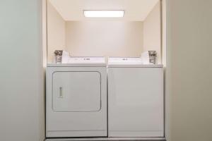 a kitchen with two refrigerators in a room at Super 8 by Wyndham Topeka/Wanamaker RD/I-70 in Topeka +26 photos