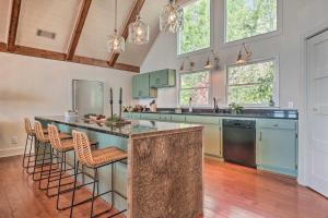 a kitchen with a large island with bar stools at Stunning Highlands Escape with Fireplace and Game Room in Highlands