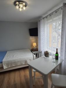 a bedroom with a bed and a table and a dining room at u eli i jurka in Sztutowo