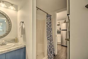 a bathroom with a shower and a sink and a mirror at Quaint Tignall Cabin with Deck and Private Dock! in Tignall