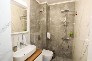a bathroom with a shower and a toilet and a sink at Glavatarski Han in Glavatartsi +114 photos