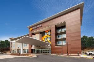 a rendering of the front of a building at La Quinta Inn & Suites by Wyndham Middletown in Middletown