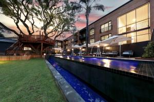 a swimming pool in front of a building at Hyatt House Johannesburg, Sandton in Johannesburg