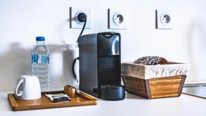 a black appliance sitting on a counter with a bottle of water at Résidence Vili Vili in Dzaoudzi