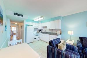 a living room with a couch and a kitchen at Jetty East Condos II in Destin