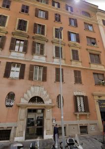 a man standing in front of a building at Vatican Sunset Guest House in Rome