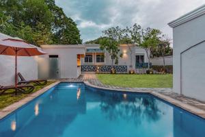 a swimming pool in front of a house at Chanpaal Hotel Boutique - Only Adults in Mérida