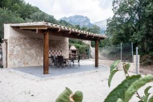 a gazebo with a table and chairs under it at La Remulla in Paúls