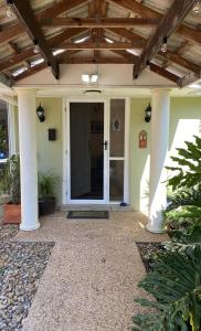 a front door of a house with a wooden ceiling at KooralBnB in Kooralbyn