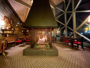 a restaurant with a fire place in the middle of it at Toll Road Inn in Manchester