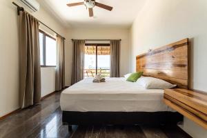 una camera da letto con un letto grande con testiera in legno di Villa with ocean view, pool, restaurant and rooftop a Isla Mujeres Altre 186 foto