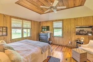a bedroom with a bed and a ceiling fan at Peaceful Cairo Farmhouse with Barn and Fire Pit in Cairo