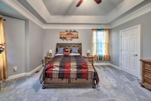 a bedroom with a bed and a ceiling fan at Dayton House with Private Hot Tub, Patio, Grill in Dayton