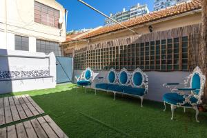 a patio with blue chairs on the grass at Classic Villa in Beato Lisbon in Lisbon