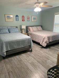 a bedroom with two beds and a ceiling fan at Sea Club Condo #37 in Clearwater Beach +45 photos