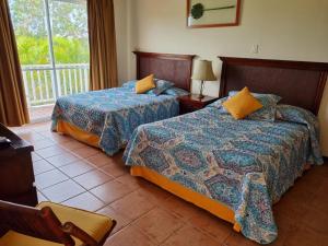 a hotel room with two beds and a balcony at Villa Angela in Playa Blanca