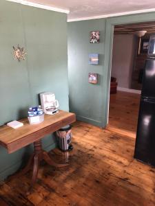 a room with a wooden table and a refrigerator at Seafarer Inn and Cottages in Old Orchard Beach