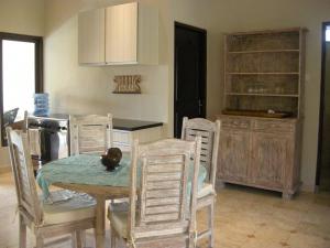 a kitchen with a table and chairs and a kitchen with a counter at Villa Jasri Point - Beachfront Villa close to surf in Jasri