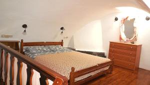 a bedroom with a bed and a dresser and a mirror at Karampela Despina in Mestá